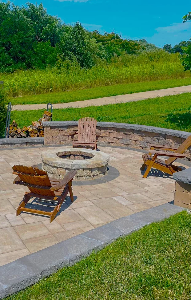 Paver patio with stone fire pit, seat wall and Adirondack chairs