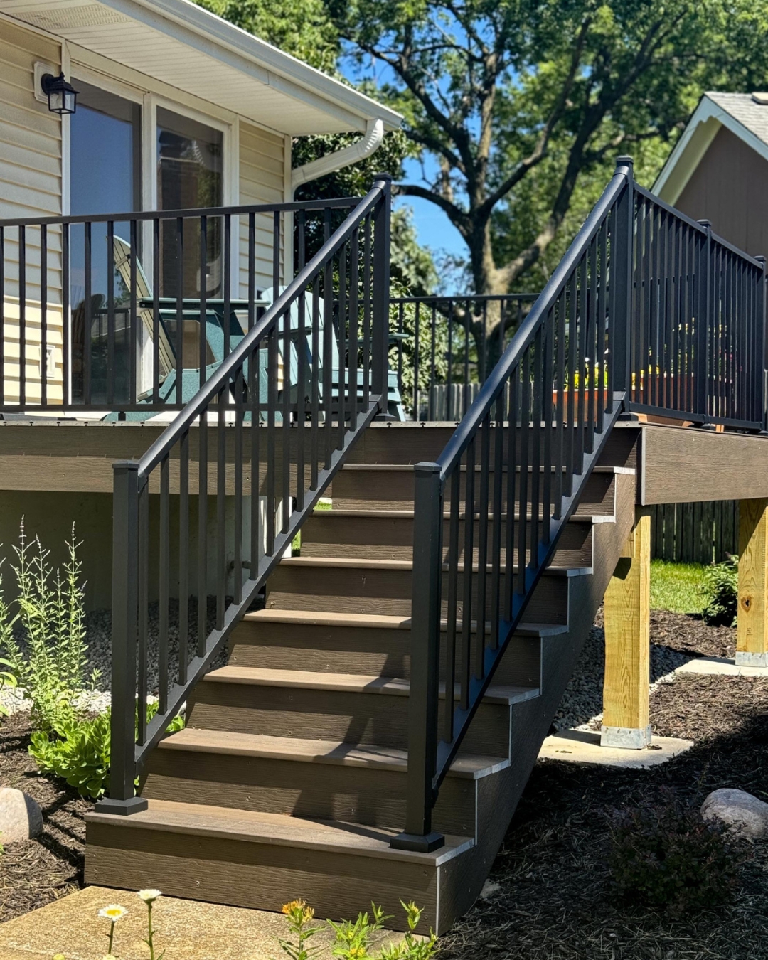 Composite deck stairs with black metal railing