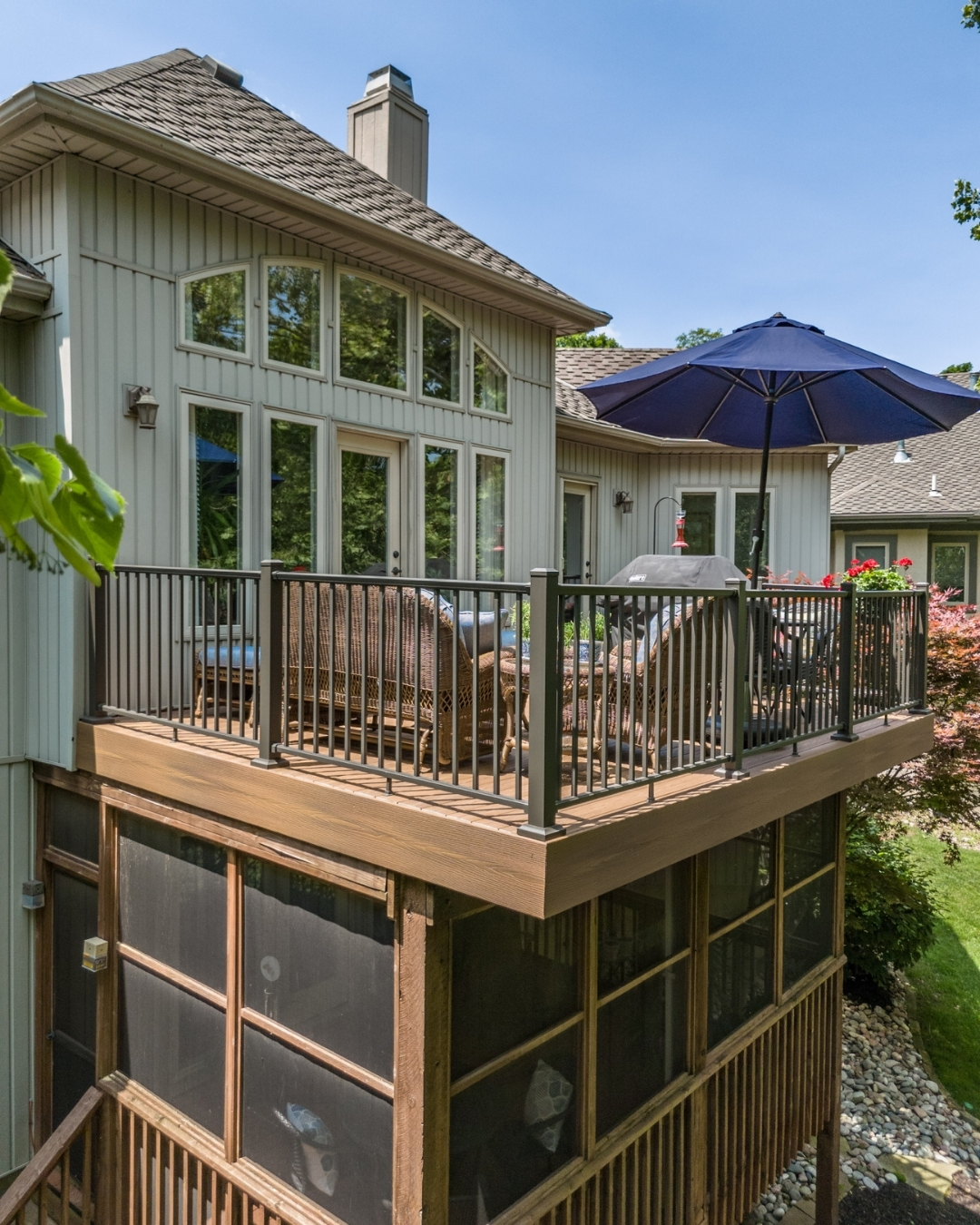 Elevated backyard deck with outdoor furniture and patio umbrella